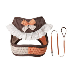 Dark brown and coral pink mesh dog harness and matching leash with a decorative bow and white lace ruffle trim.