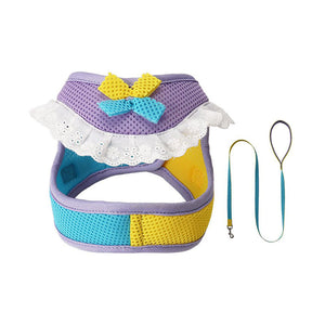 Lavender mesh dog harness and matching leash with yellow and aqua blue accents, a bow, and white lace ruffle trim.