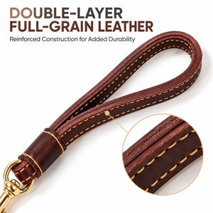 Close-up of the double-layer full-grain leather handle on a short traffic dog leash with stitched edges