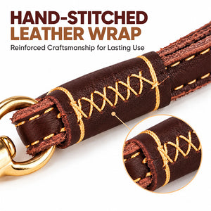 Close-up of hand-stitched leather wrap with cross stitching near the brass ring of a dog leash