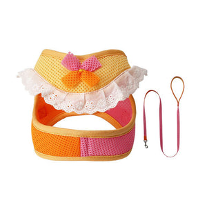 Yellow and orange mesh dog harness and matching pink leash with a colorful bow and white lace ruffle trim.