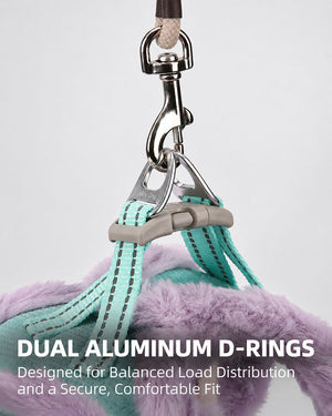 Close-up of dual aluminum D-rings on a Mint Turquoise and Lilac dog harness, showing the leash attachment hardware and reinforced webbing.