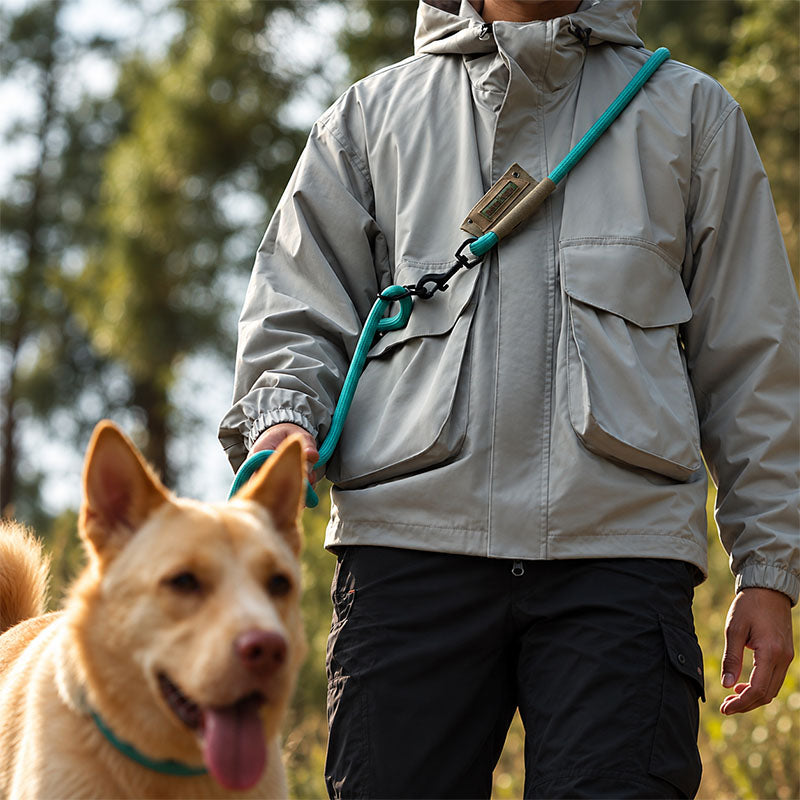 Turquoise hands-free dog leash worn crossbody during an outdoor walk with a dog